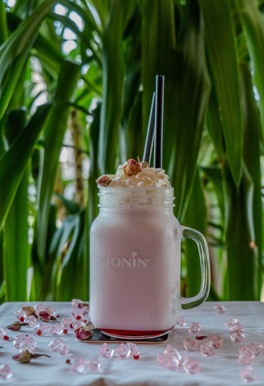 Pink signature shake with greenery backdrop