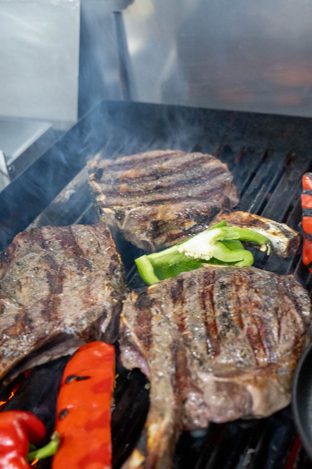 Steaks on grill with vegetables